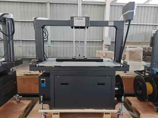 Calidad  Semi-Automatic 1200mm Carton Box Strapping Machine with One Year Warranty for Efficient Packing Fábrica